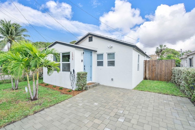 135 NE 11th Ave, Boynton Beach, FL 33435 - view of front of home with stucco siding and a patio area