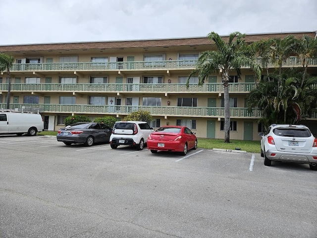 300 Village Green Cir S Unit 206, Palm Springs, FL 33461 - view of building exterior featuring uncovered parking