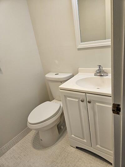 300 Village Green Cir S Unit 206, Palm Springs, FL 33461 - bathroom with vanity, tile patterned flooring, and toilet