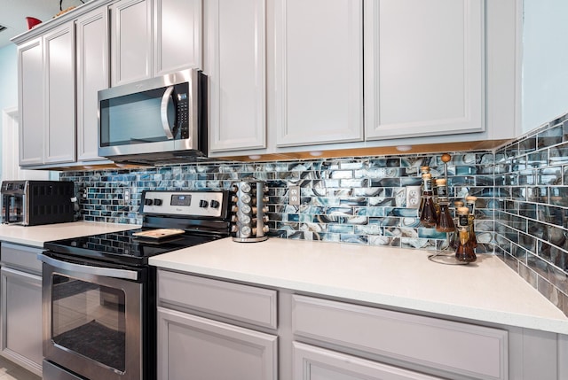 1908 Harding St, Lake Worth, FL 33460 - kitchen with appliances with stainless steel finishes, tasteful backsplash, and light countertops
