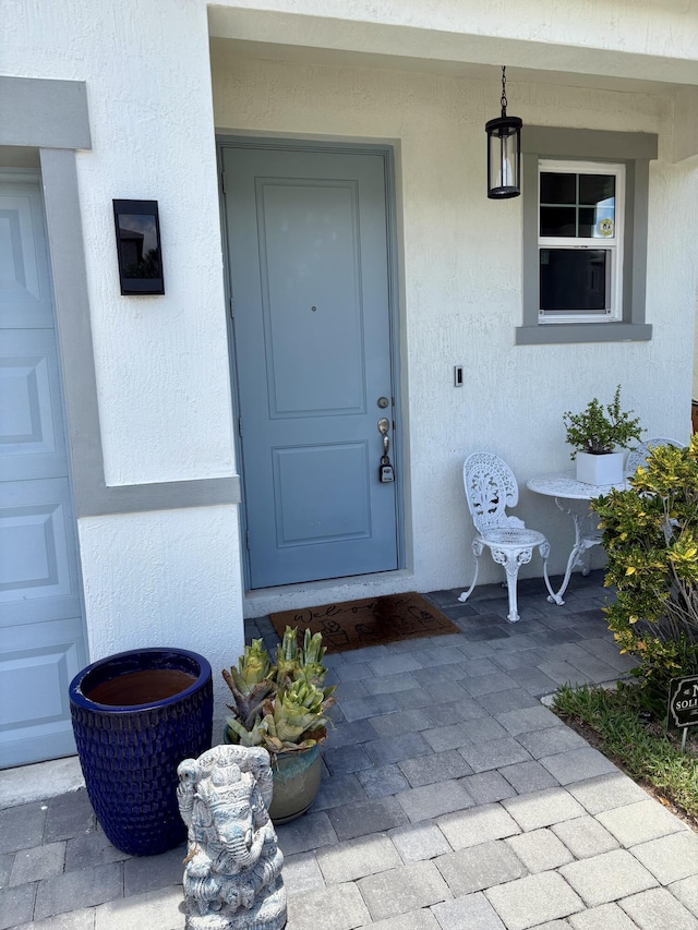 1908 Harding St, Lake Worth, FL 33460 - view of exterior entry with stucco siding and covered porch