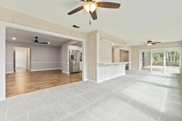7 Riverview Dr, Sewalls Point, FL 34996 - unfurnished living room with baseboards, a ceiling fan, and visible vents