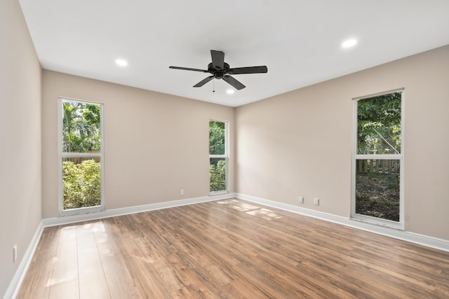 7 Riverview Dr, Sewalls Point, FL 34996 - empty room with wood finished floors, baseboards, and a wealth of natural light