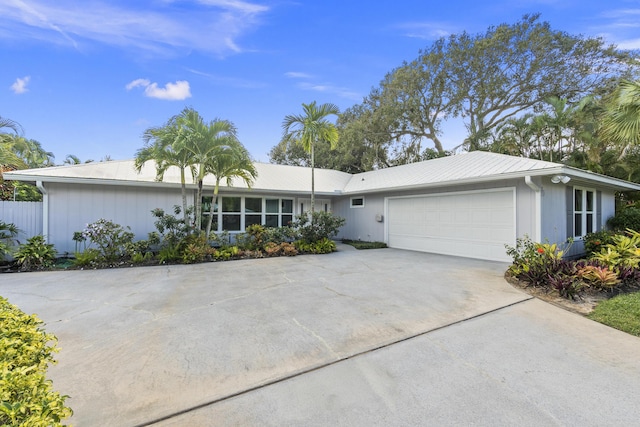 7 Riverview Dr, Sewalls Point, FL 34996 - ranch-style house with an attached garage and concrete driveway