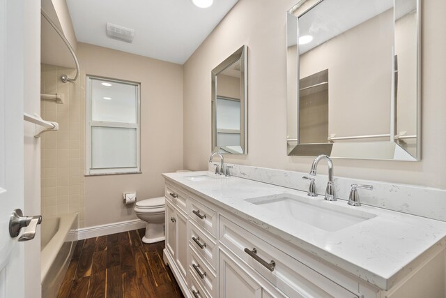 7 Riverview Dr, Sewalls Point, FL 34996 - bathroom with toilet, wood finished floors, a sink, and baseboards