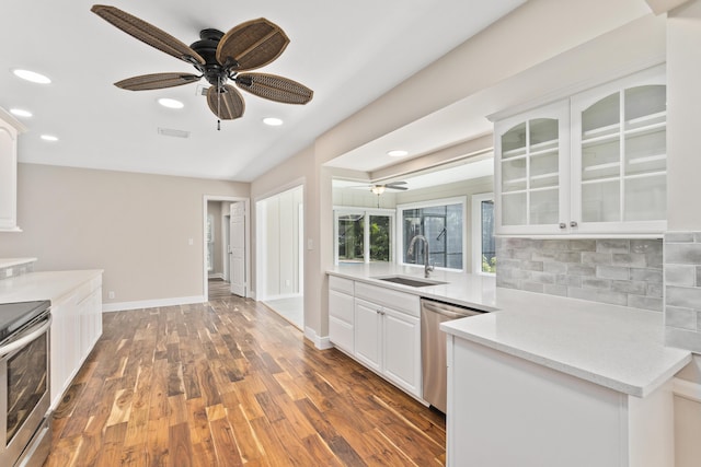 7 Riverview Dr, Sewalls Point, FL 34996 - kitchen featuring a sink, a ceiling fan, glass insert cabinets, and stainless steel appliances