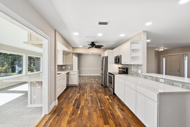 7 Riverview Dr, Sewalls Point, FL 34996 - kitchen featuring a peninsula, white cabinetry, open shelves, visible vents, and appliances with stainless steel finishes