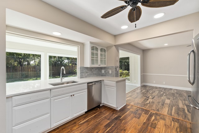 7 Riverview Dr, Sewalls Point, FL 34996 - kitchen featuring glass insert cabinets, light countertops, backsplash, stainless steel appliances, and a sink