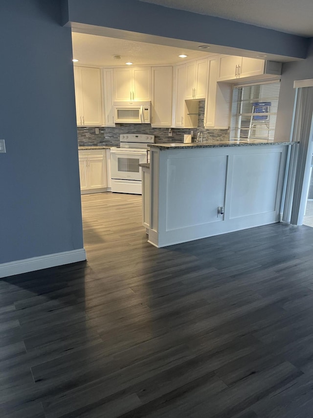 kitchen featuring backsplash, dark stone counters, white appliances, white cabinets, and dark wood-style floors