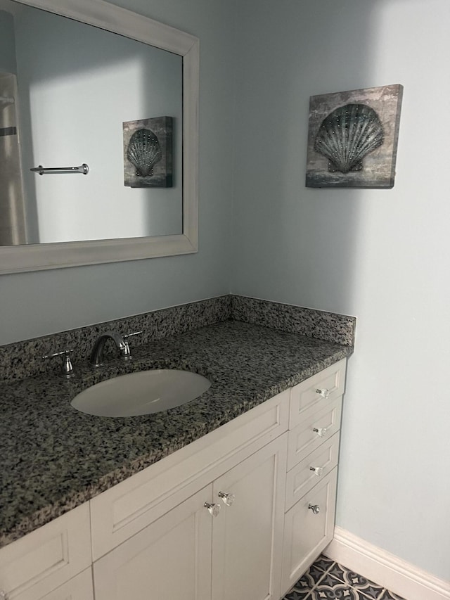 bathroom with vanity and baseboards