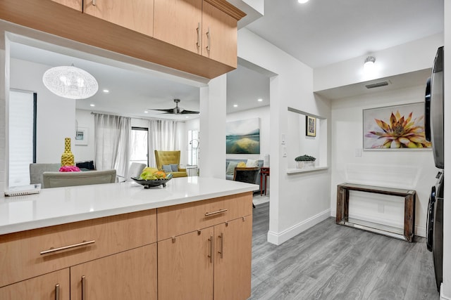 1013 Green Pine Blvd Unit A1, West Palm Beach, FL 33409 - kitchen featuring estacked washer and dryer, light wood-style flooring, light countertops, open floor plan, and recessed lighting