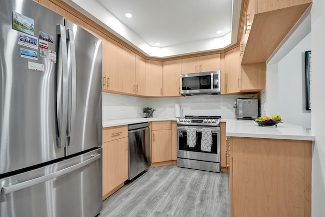 1013 Green Pine Blvd Unit A1, West Palm Beach, FL 33409 - kitchen with stainless steel appliances, light brown cabinetry, light wood finished floors, light countertops, and recessed lighting