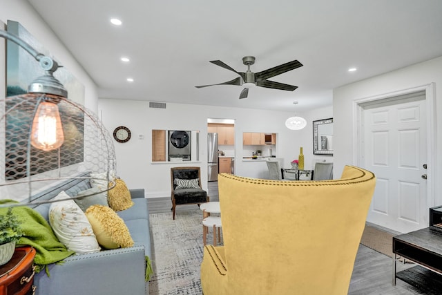 1013 Green Pine Blvd Unit A1, West Palm Beach, FL 33409 - living room with recessed lighting, light wood-style flooring, a ceiling fan, baseboards, and stacked washing machine and dryer