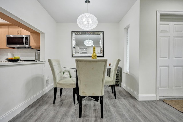 1013 Green Pine Blvd Unit A1, West Palm Beach, FL 33409 - dining room with wood finished floors, a chandelier, and baseboards