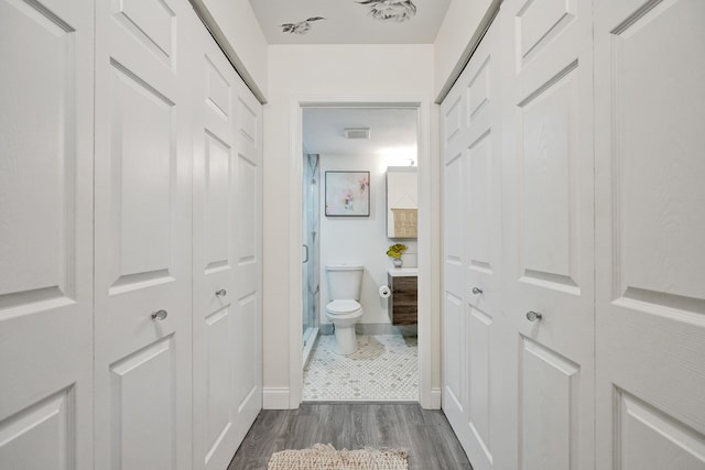 1013 Green Pine Blvd Unit A1, West Palm Beach, FL 33409 - hallway with dark wood-style flooring and baseboards