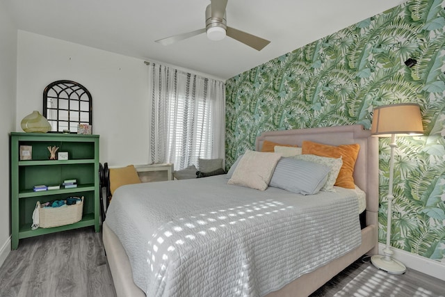 1013 Green Pine Blvd Unit A1, West Palm Beach, FL 33409 - bedroom featuring wallpapered walls, baseboards, wood finished floors, and ceiling fan