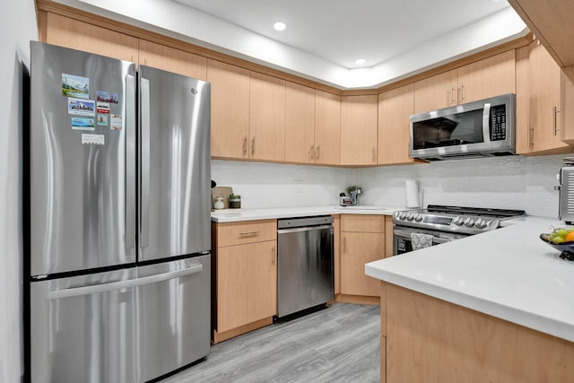 1013 Green Pine Blvd Unit A1, West Palm Beach, FL 33409 - kitchen with stainless steel appliances, light brown cabinetry, light countertops, backsplash, and recessed lighting