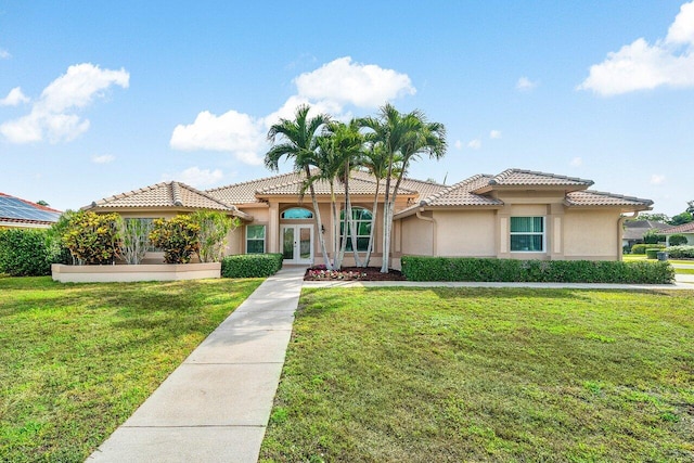 2020 Newhaven Ave, Wellington, FL 33414 - mediterranean / spanish-style home featuring french doors, stucco siding, a tiled roof, and a front yard