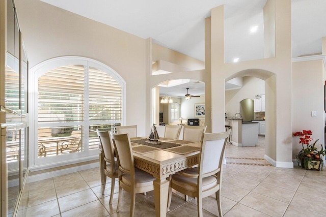 2020 Newhaven Ave, Wellington, FL 33414 - dining space with arched walkways, a ceiling fan, light tile patterned flooring, and baseboards