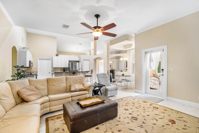 2020 Newhaven Ave, Wellington, FL 33414 - living room featuring arched walkways, a ceiling fan, light tile patterned floors, and baseboards