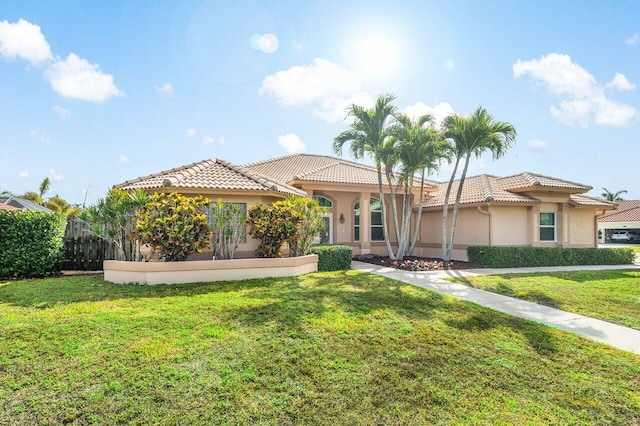 2020 Newhaven Ave, Wellington, FL 33414 - mediterranean / spanish home featuring a tiled roof, stucco siding, and a front lawn