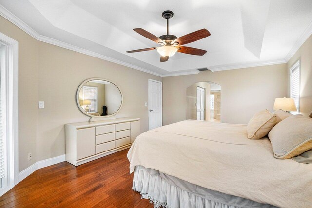 2020 Newhaven Ave, Wellington, FL 33414 - bedroom featuring arched walkways, dark wood-type flooring, crown molding, baseboards, and ceiling fan