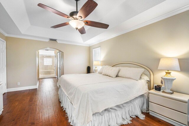 2020 Newhaven Ave, Wellington, FL 33414 - bedroom with a raised ceiling, arched walkways, dark wood-type flooring, crown molding, and baseboards