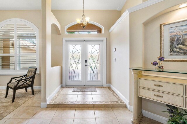 2020 Newhaven Ave, Wellington, FL 33414 - foyer featuring a chandelier, light tile patterned floors, french doors, and baseboards