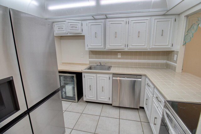 800 Parkview Dr Unit 826, Hallandale Beach, FL 33009 - kitchen featuring white cabinets, stainless steel appliances, a sink, and wine cooler