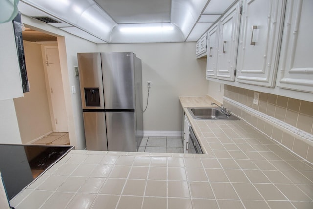 800 Parkview Dr Unit 826, Hallandale Beach, FL 33009 - kitchen featuring visible vents, stainless steel fridge, tile countertops, white cabinets, and a sink