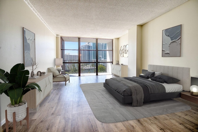 800 Parkview Dr Unit 826, Hallandale Beach, FL 33009 - bedroom with expansive windows, a view of city, a textured ceiling, and wood finished floors