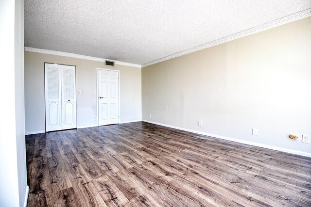 800 Parkview Dr Unit 826, Hallandale Beach, FL 33009 - unfurnished bedroom featuring visible vents, ornamental molding, baseboards, a textured ceiling, and dark wood finished floors