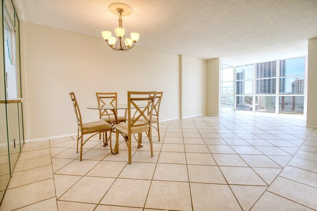 800 Parkview Dr Unit 826, Hallandale Beach, FL 33009 - dining space featuring expansive windows, light tile patterned flooring, a textured ceiling, and a notable chandelier