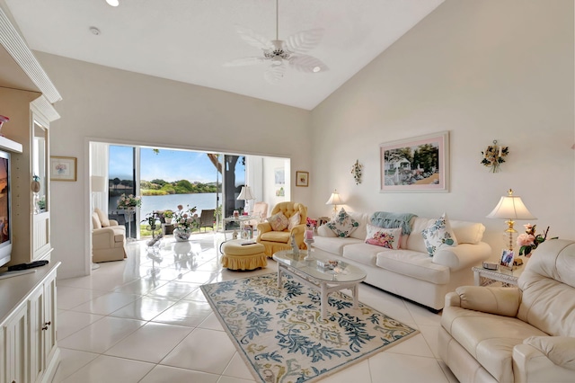 living area with a water view, light tile patterned floors, ceiling fan, and high vaulted ceiling