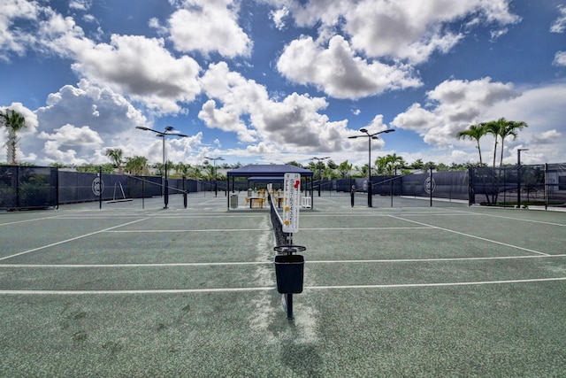 view of sport court with fence and a gazebo