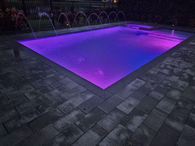 pool featuring fence and a patio