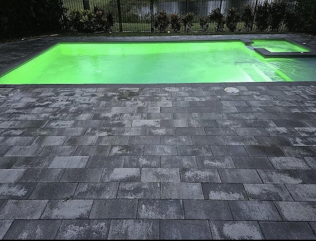 exterior details with a hot tub and roof with shingles