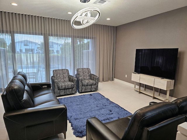 living area featuring baseboards, recessed lighting, a chandelier, and visible vents