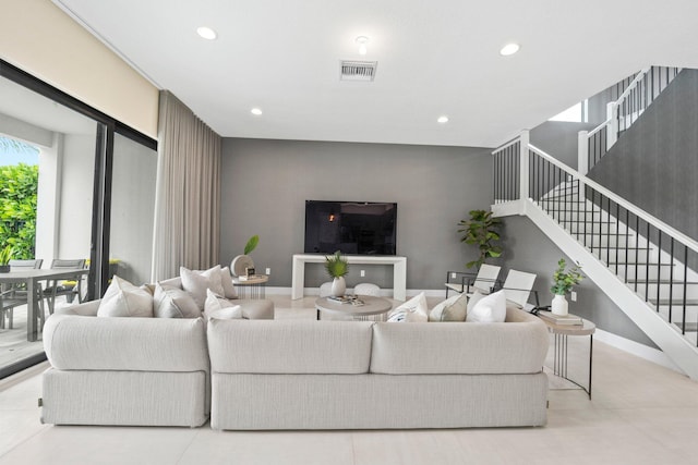 living area with visible vents, stairway, and recessed lighting