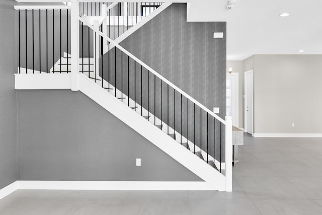 stairway with baseboards and recessed lighting