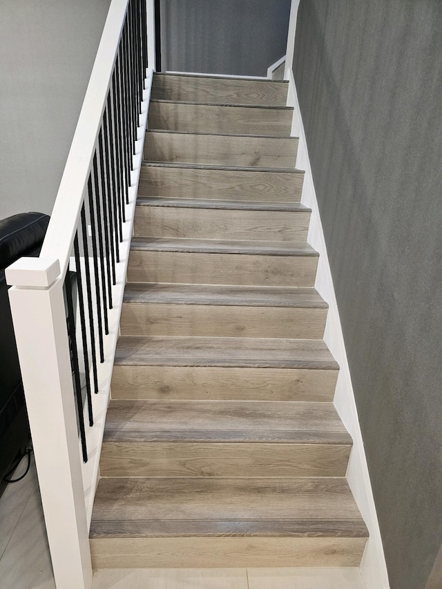 stairway featuring wood finished floors