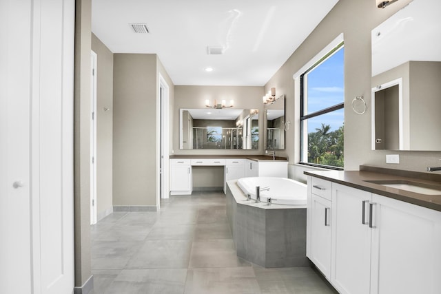 bathroom featuring visible vents, a bath, a sink, a shower stall, and two vanities