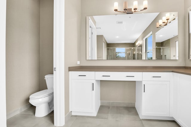 bathroom with vanity, tile patterned flooring, a shower stall, and toilet