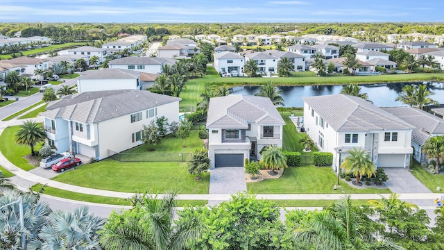 drone / aerial view with a water view and a residential view