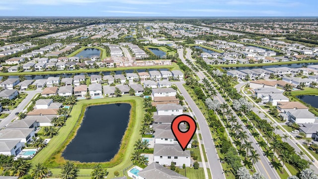 drone / aerial view with a water view and a residential view
