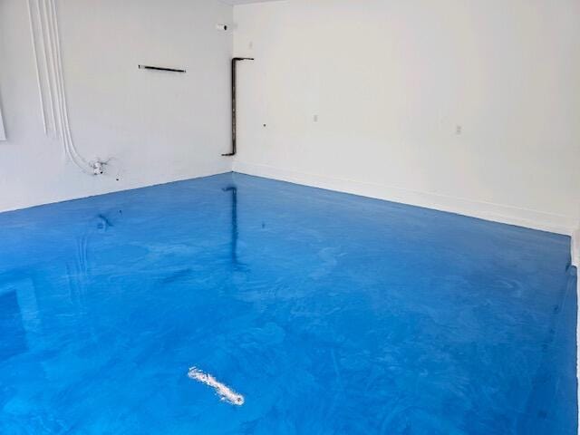 interior space featuring baseboards and concrete floors