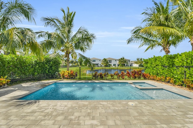 view of pool featuring a pool with connected hot tub, a residential view, and a fenced backyard