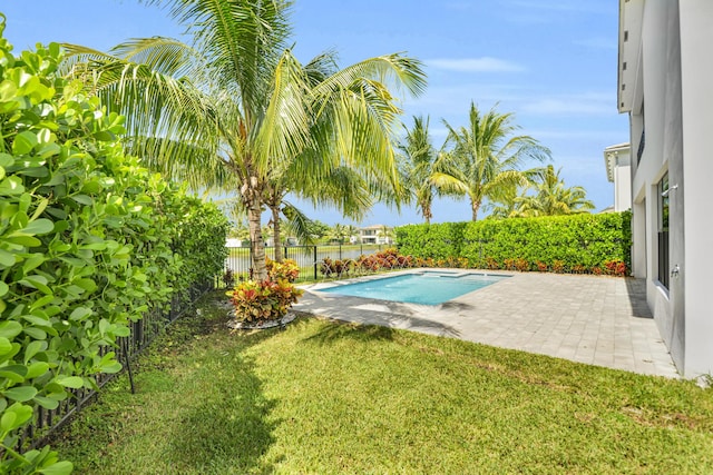 view of swimming pool featuring a patio, a water view, a lawn, a fenced backyard, and a fenced in pool