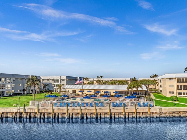 dock area with a yard and a water view