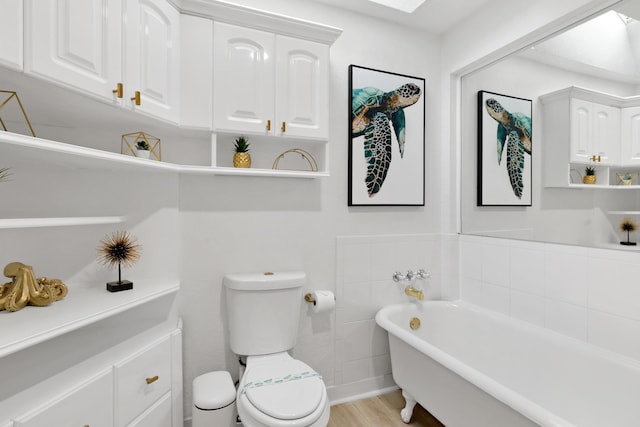 1021 N Palmway, Lake Worth Beach, FL 33460 - bathroom with a freestanding tub, toilet, and wood finished floors